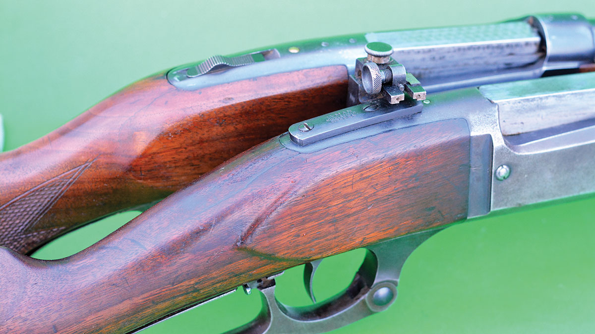 Early Model 1899 rifles (close) featured a sliding safety that locks the lever closed, while later production guns (far) feature an improved sliding tang mounted design.